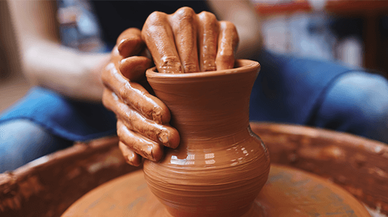 Hands Making Curve On Clay Pot