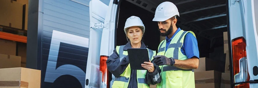 A Female Worker Explaining To Male Worker Using Tablet