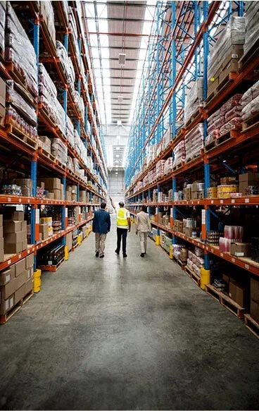 Supervisor Addressing Stocks To Two People At Warehouse