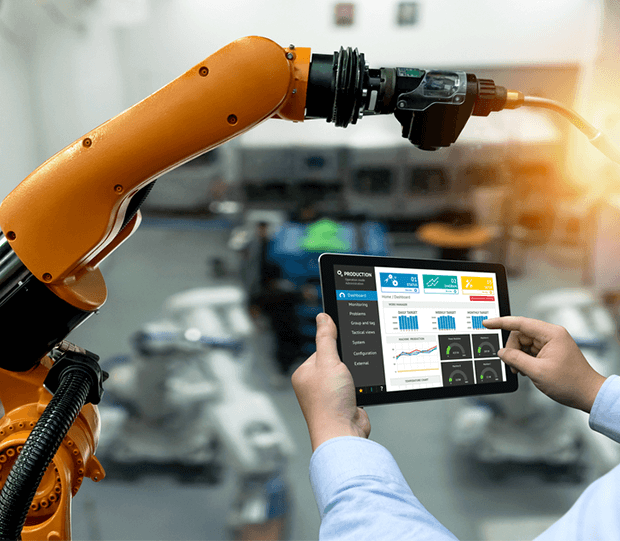 A Man Using A Tablet To Control Machinery In Engineering Industry